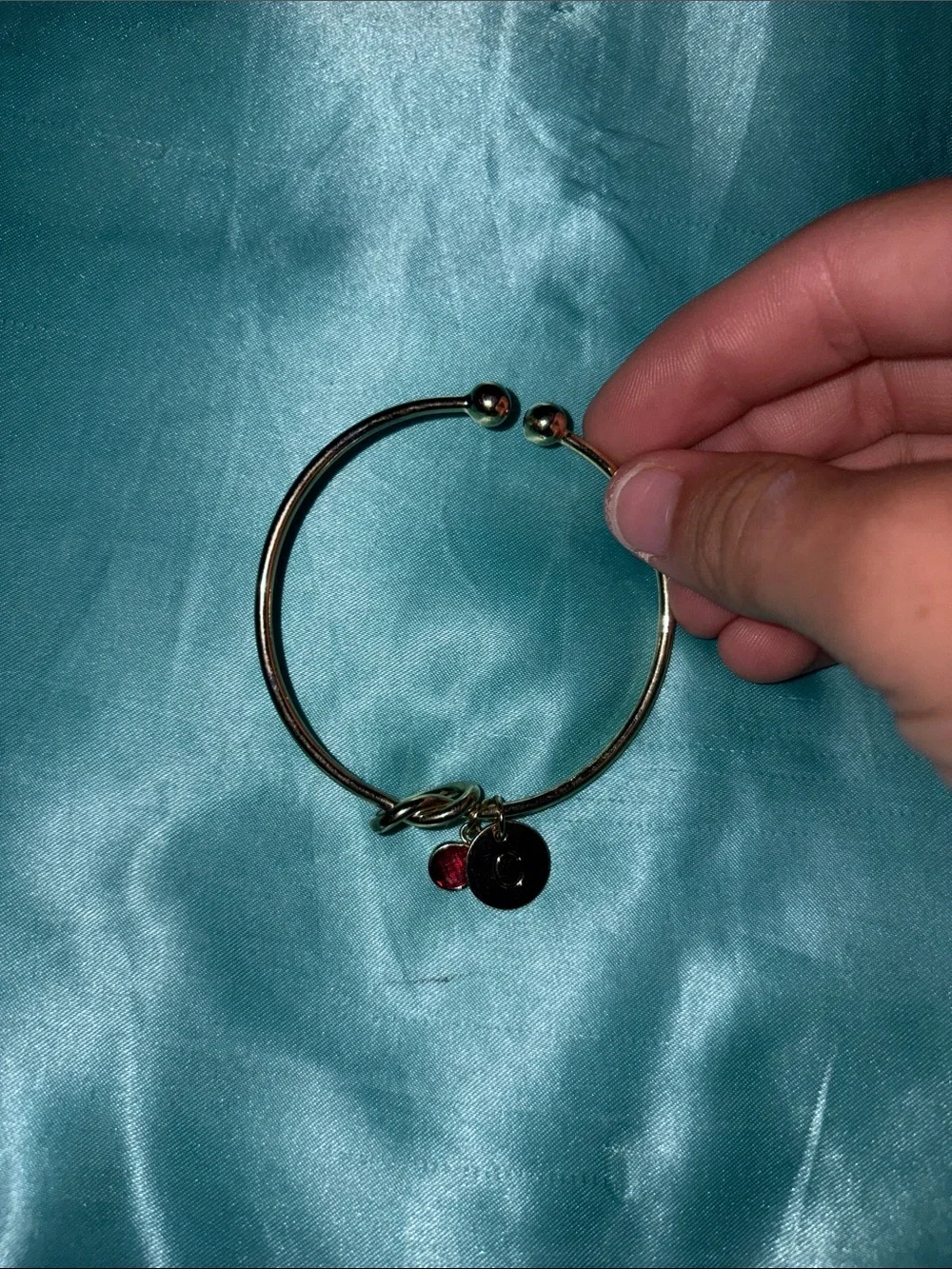 Gold Tone Charm Bangle Bracelet with Red Crystal Accent